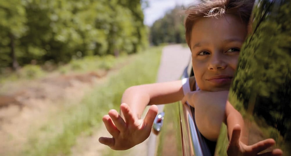 child looking out car window