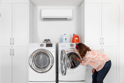 Home heat pump clothes dryer below a mini-split air source heat pump