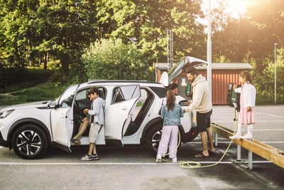 a family charging an EV