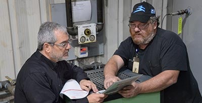 Two men looking at a report.