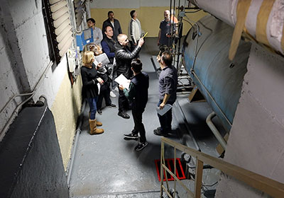 Group of people in a boiler room participating in Ross Energy on-site training.